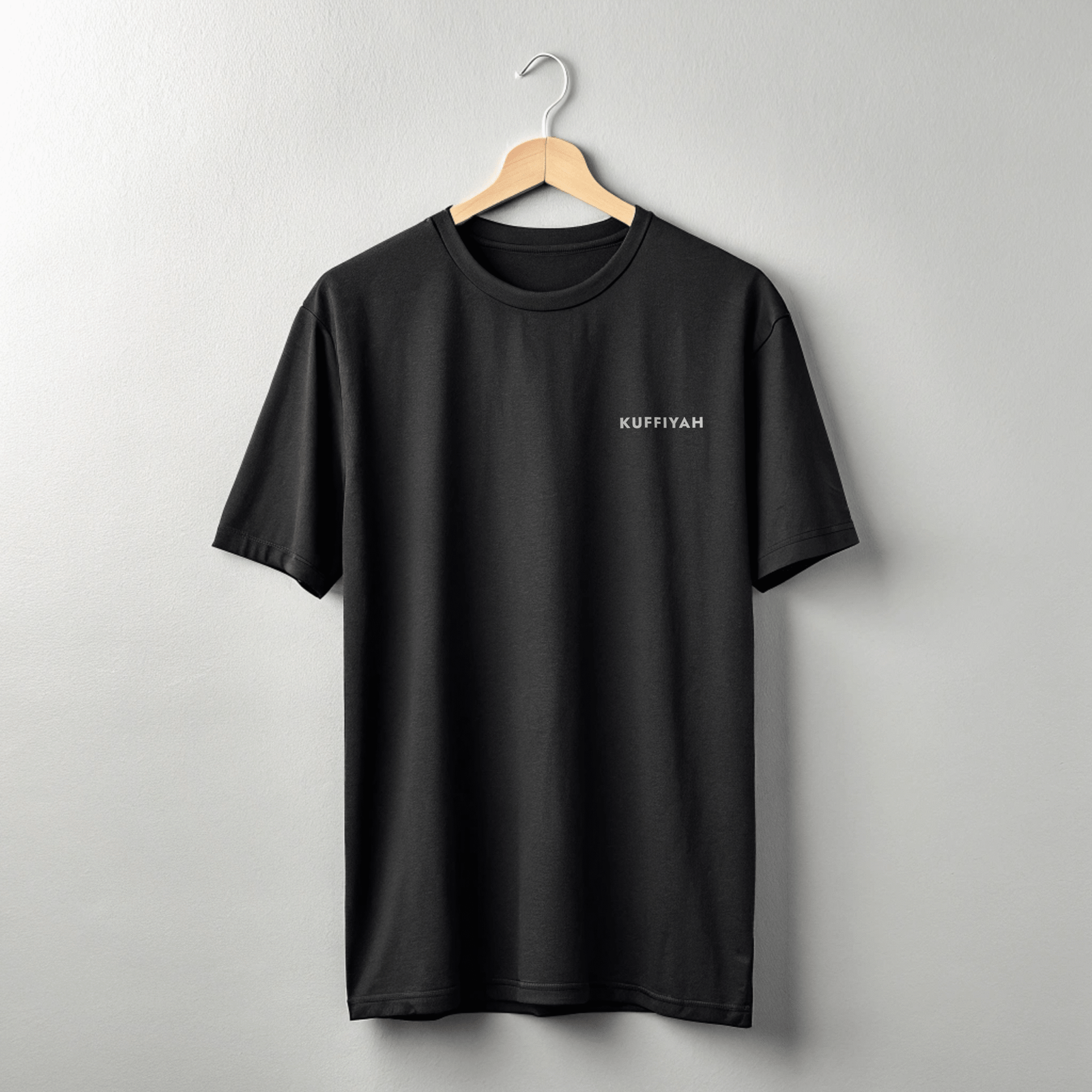 Front view of black keffiyeh clothing tee with subtle olive leaves band