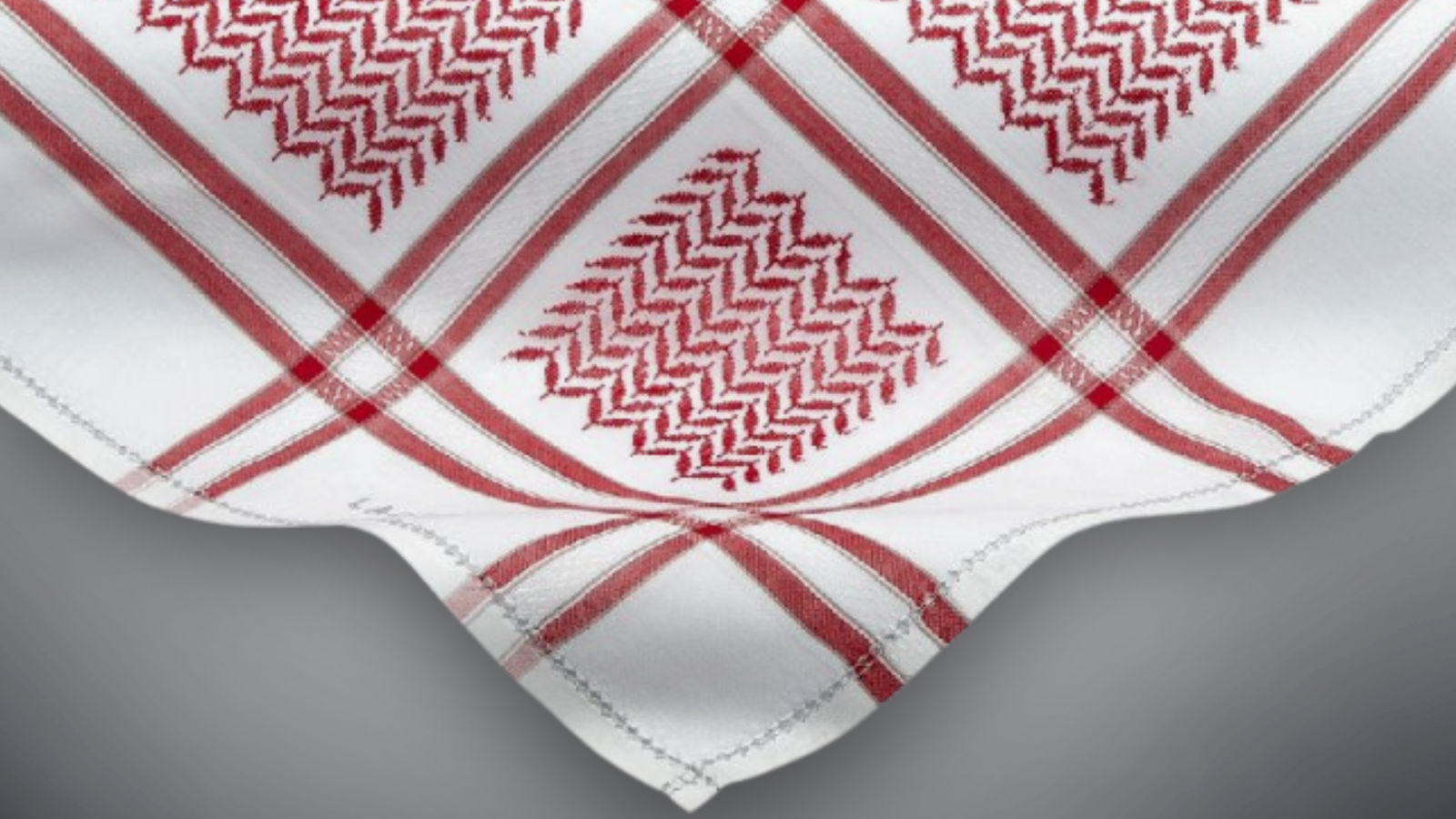 Close up of a red keffiyeh pattern on white fabric