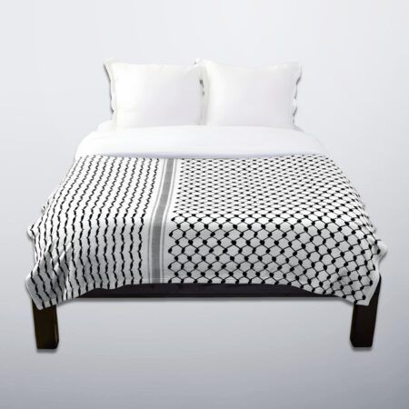 Palestinian keffiyeh throw blanket spread across a white bed